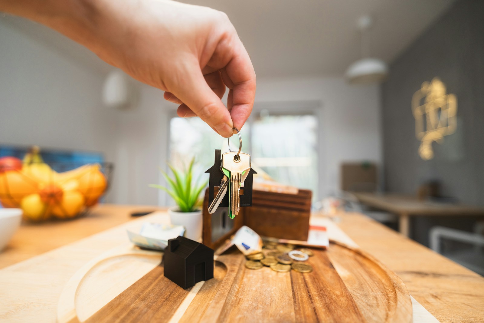 A person holding a piece of wood on top of a wooden table, homeowner